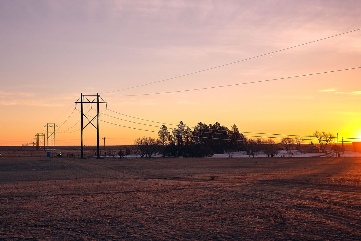 Transmission lines at sunrise in rural area