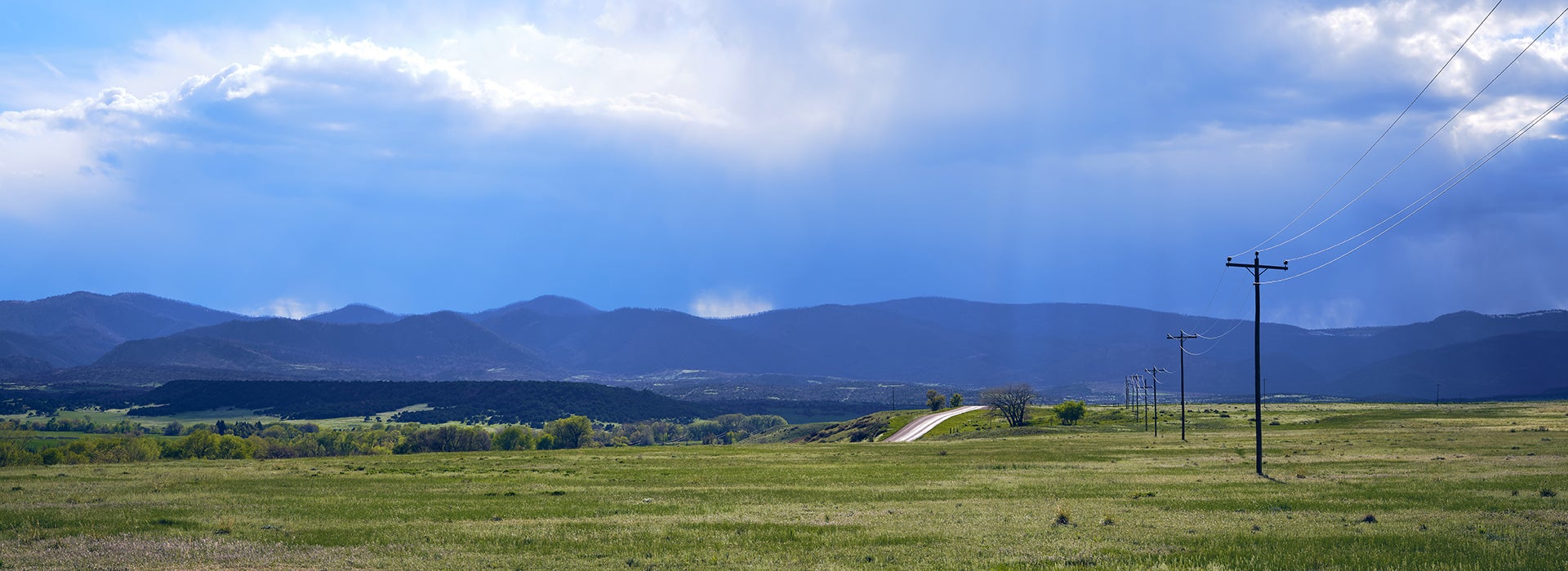 Rolling countryside with transmission lines in a field